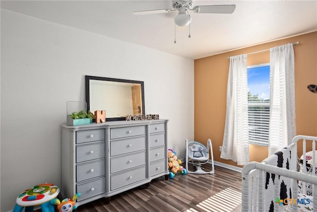 5607 Schorn Dr, Killeen, TX 76542 - bedroom featuring dark wood-type flooring, a crib, baseboards, and ceiling fan