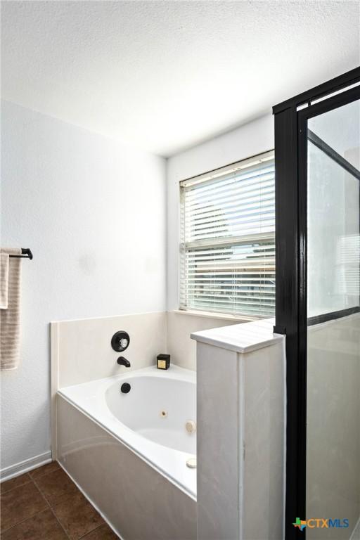 5607 Schorn Dr, Killeen, TX 76542 - full bathroom featuring a jetted tub and a shower stall