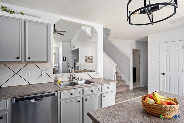 5607 Schorn Dr, Killeen, TX 76542 - kitchen with stainless steel dishwasher, a sink, ceiling fan, light wood finished floors, and decorative backsplash