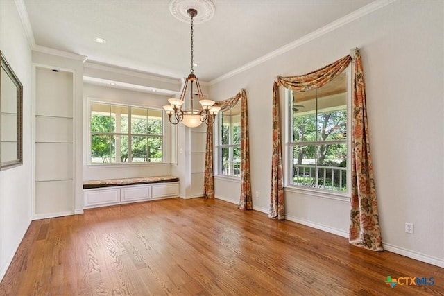 11740 Stinnett Mill Rd, Salado, TX 76571 - unfurnished dining area featuring a chandelier, wood finished floors, and crown molding