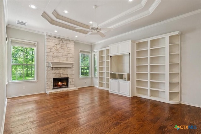 11740 Stinnett Mill Rd, Salado, TX 76571 - unfurnished living room featuring wood finished floors, ceiling fan, a stone fireplace, a tray ceiling, and recessed lighting