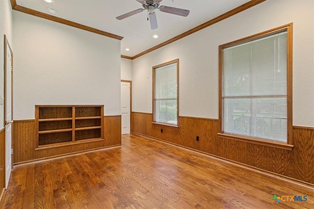 11740 Stinnett Mill Rd, Salado, TX 76571 - unfurnished room featuring a wainscoted wall, crown molding, wood finished floors, wooden walls, and ceiling fan