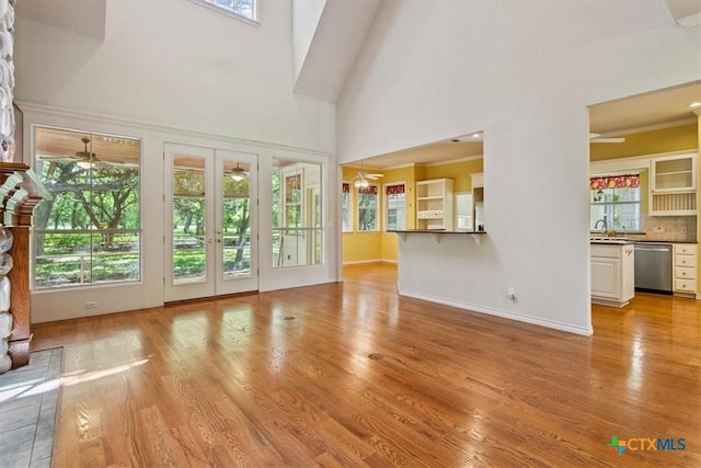 11740 Stinnett Mill Rd, Salado, TX 76571 - unfurnished living room with a high ceiling, light wood-type flooring, and ceiling fan