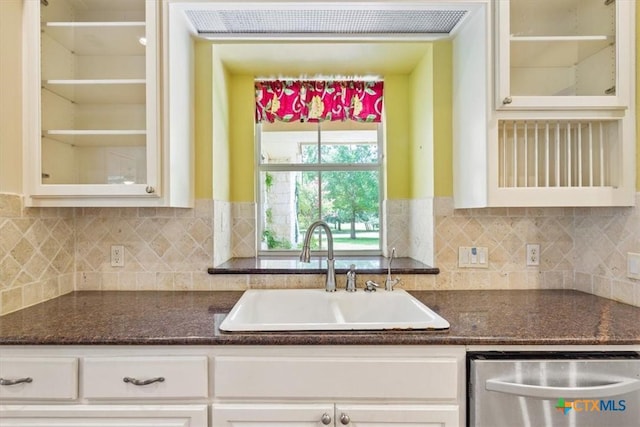 11740 Stinnett Mill Rd, Salado, TX 76571 - kitchen with stainless steel dishwasher, glass insert cabinets, white cabinets, and dark stone counters