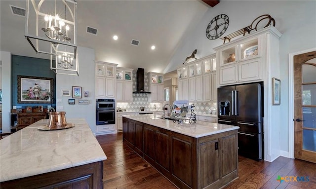 750 Mission Hts, New Braunfels, TX 78130 - kitchen featuring visible vents, high end black refrigerator, wall chimney range hood, a spacious island, and a notable chandelier