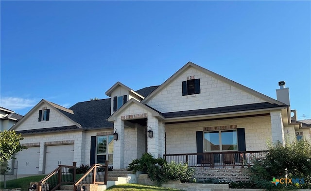 750 Mission Hts, New Braunfels, TX 78130 - view of front facade featuring a shingled roof, an attached garage, stone siding, a porch, and a standing seam roof
