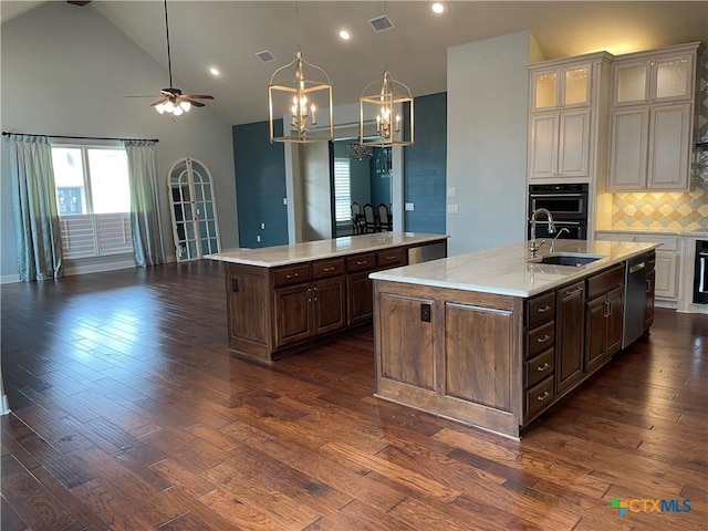 750 Mission Hts, New Braunfels, TX 78130 - kitchen with a sink, a kitchen island with sink, dark wood-type flooring, stainless steel dishwasher, and visible vents