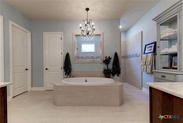 750 Mission Hts, New Braunfels, TX 78130 - full bath with vanity, tile patterned flooring, a garden tub, and a notable chandelier