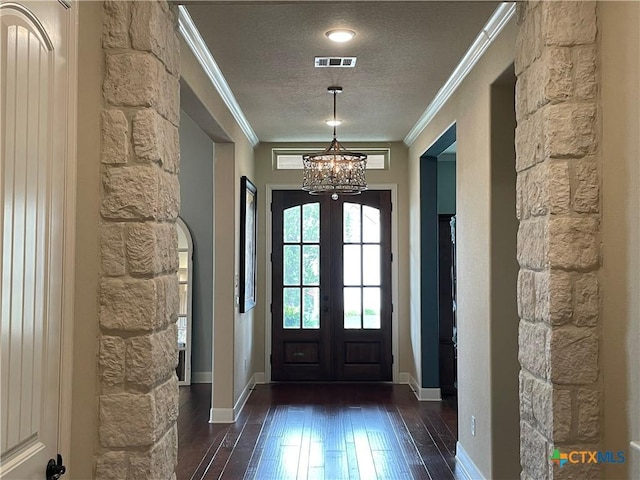 750 Mission Hts, New Braunfels, TX 78130 - doorway to outside with wood-type flooring, ornamental molding, a textured ceiling, and a notable chandelier