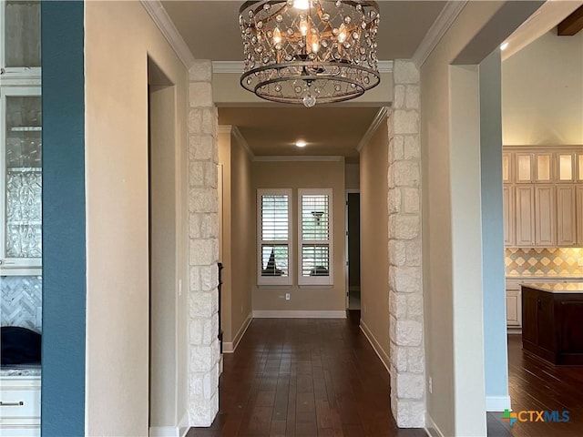 750 Mission Hts, New Braunfels, TX 78130 - hallway with crown molding, dark wood-style floors, and an inviting chandelier