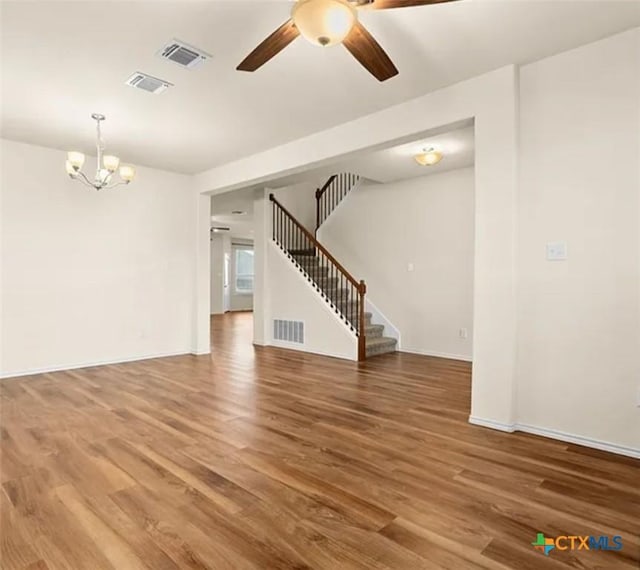 5561 Perdita Dr, Belton, TX 76513 - interior space featuring visible vents, stairway, wood finished floors, and ceiling fan with notable chandelier
