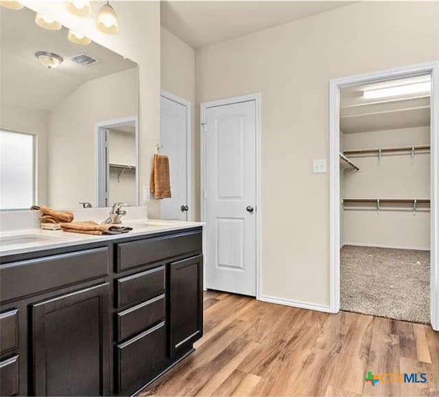 5561 Perdita Dr, Belton, TX 76513 - bathroom featuring double vanity, wood finished floors, visible vents, and a sink