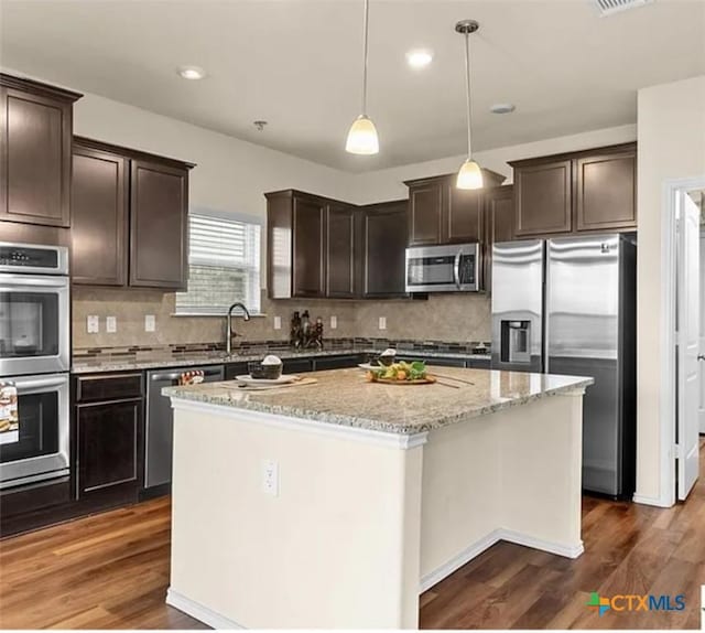 5561 Perdita Dr, Belton, TX 76513 - kitchen featuring a sink, stainless steel appliances, dark brown cabinets, a center island, and dark wood-type flooring