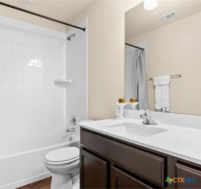 5561 Perdita Dr, Belton, TX 76513 - bathroom featuring wood finished floors, shower / bath combination with curtain, toilet, vanity, and visible vents