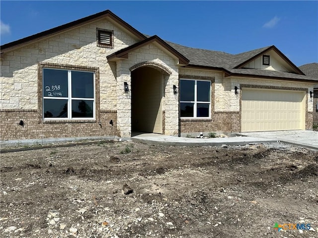 2598 Settlers Oak Dr, Belton, TX 76513 - view of front of house with a garage, concrete driveway, stone siding, and brick siding