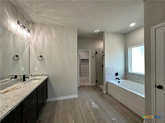 2598 Settlers Oak Dr, Belton, TX 76513 - full bath featuring a stall shower, a textured ceiling, a bath, vanity, and wood finished floors