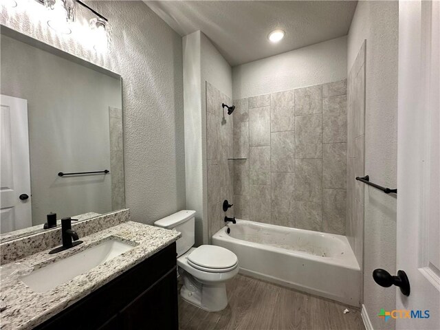 2598 Settlers Oak Dr, Belton, TX 76513 - full bathroom with a textured wall, toilet, wood finished floors, vanity, and  shower combination