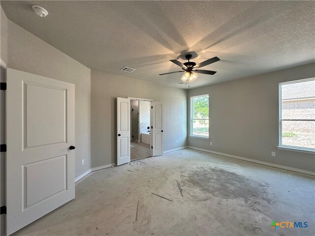 2598 Settlers Oak Dr, Belton, TX 76513 - unfurnished bedroom with a textured ceiling, baseboards, unfinished concrete floors, and a ceiling fan