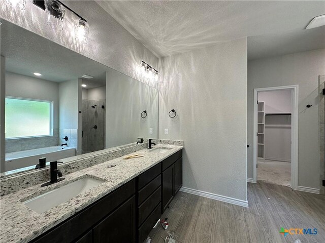 2598 Settlers Oak Dr, Belton, TX 76513 - full bath featuring a stall shower, wood finished floors, a walk in closet, double vanity, and a bath
