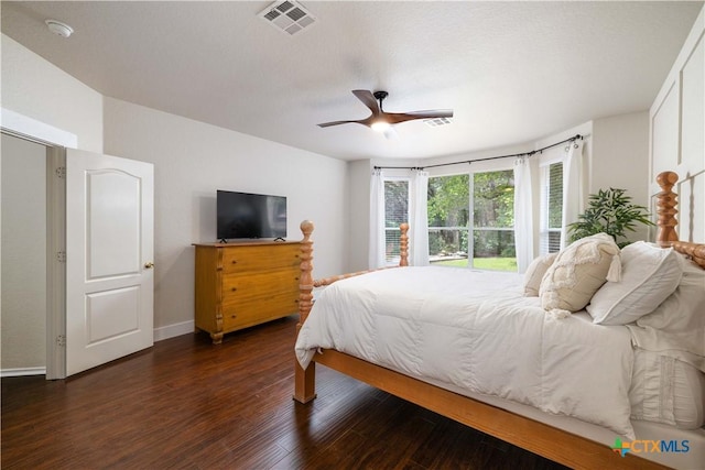 729 San Gabriel Loop, New Braunfels, TX 78132 - bedroom with dark wood finished floors, ceiling fan, and baseboards