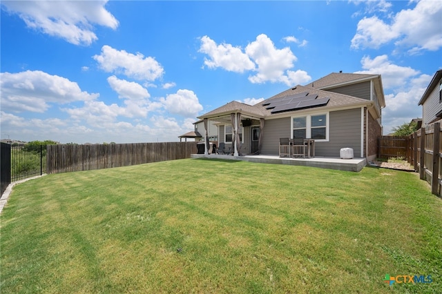 11820 Offaly Dr, Austin, TX 78754 - rear view of property with roof mounted solar panels, a fenced backyard, a patio, and roof with shingles