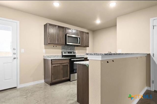 kitchen with dark brown cabinets, baseboards, recessed lighting, and stainless steel appliances