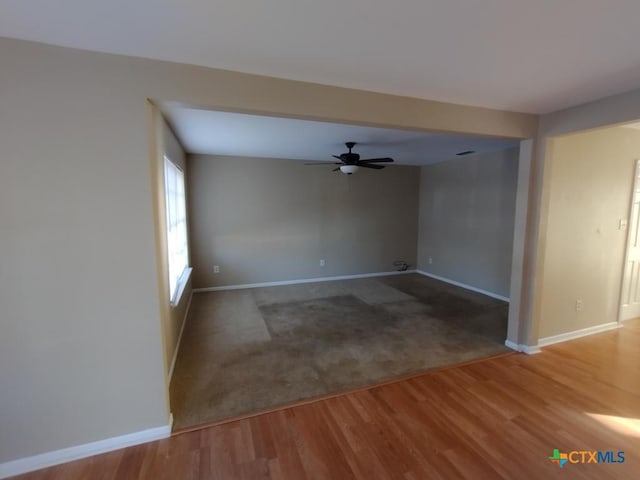 spare room featuring wood-type flooring and ceiling fan