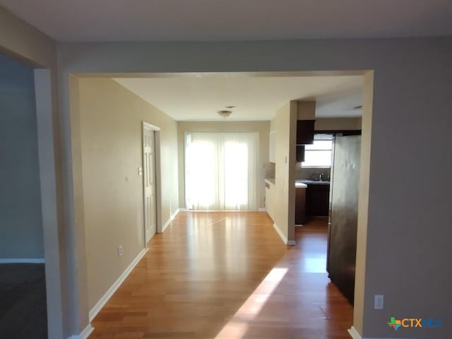 hall with sink and hardwood / wood-style flooring