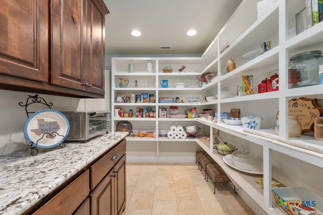 pantry featuring visible vents and a toaster