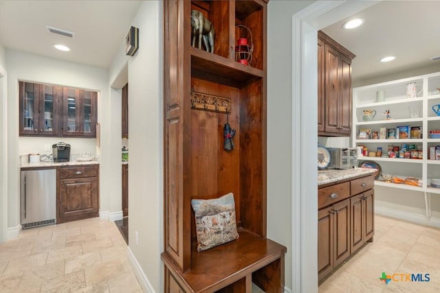 mudroom with visible vents, recessed lighting, baseboards, and stone finish flooring