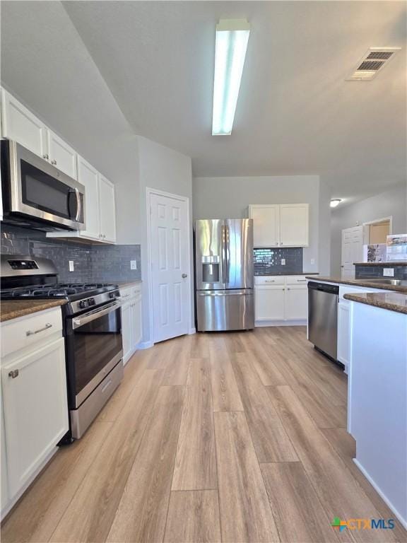 3300 Porter Creek Cv, Round Rock, TX 78665 - kitchen featuring white cabinetry, visible vents, backsplash, and appliances with stainless steel finishes