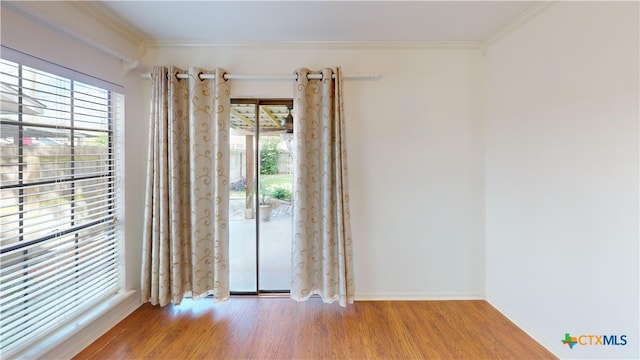 210 Londonderry Dr, Victoria, TX 77901 - empty room featuring crown molding, wood finished floors, and healthy amount of natural light