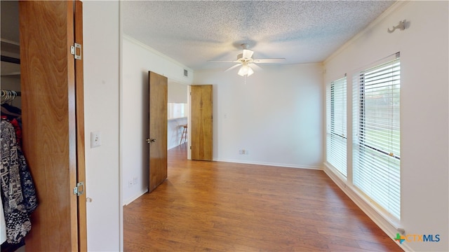 210 Londonderry Dr, Victoria, TX 77901 - spare room with a textured ceiling, ornamental molding, a ceiling fan, and wood finished floors