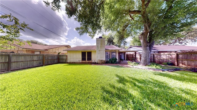 210 Londonderry Dr, Victoria, TX 77901 - back of house with a chimney and a fenced backyard