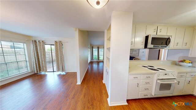 210 Londonderry Dr, Victoria, TX 77901 - kitchen featuring stainless steel microwave, electric stove, wood finished floors, and light countertops