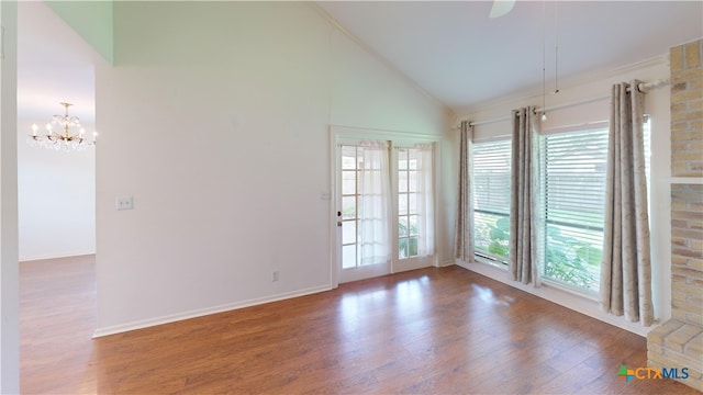 210 Londonderry Dr, Victoria, TX 77901 - unfurnished room featuring wood finished floors, a chandelier, and high vaulted ceiling
