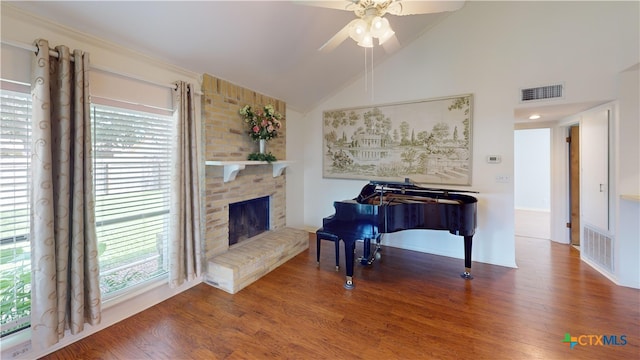 210 Londonderry Dr, Victoria, TX 77901 - sitting room with ceiling fan, lofted ceiling, wood finished floors, healthy amount of natural light, and a fireplace