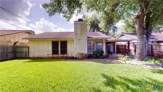 210 Londonderry Dr, Victoria, TX 77901 - rear view of house featuring a chimney, a fenced backyard, and a shingled roof
