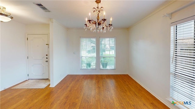 210 Londonderry Dr, Victoria, TX 77901 - unfurnished dining area with light wood-style flooring, a chandelier, and ornamental molding