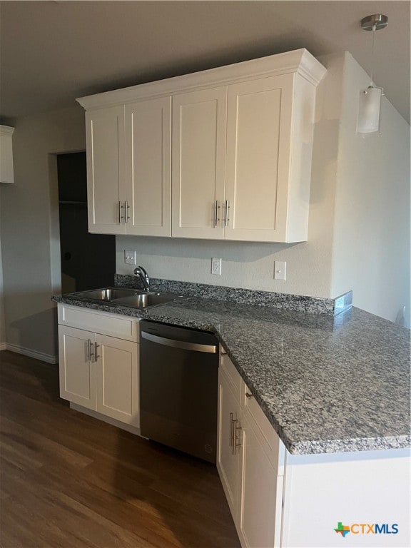 kitchen featuring dishwasher, white cabinets, sink, dark hardwood / wood-style floors, and dark stone countertops