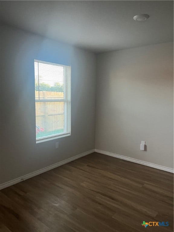 empty room featuring dark wood-type flooring