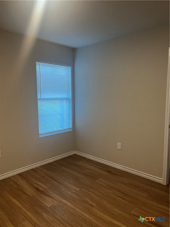 spare room featuring dark wood-type flooring