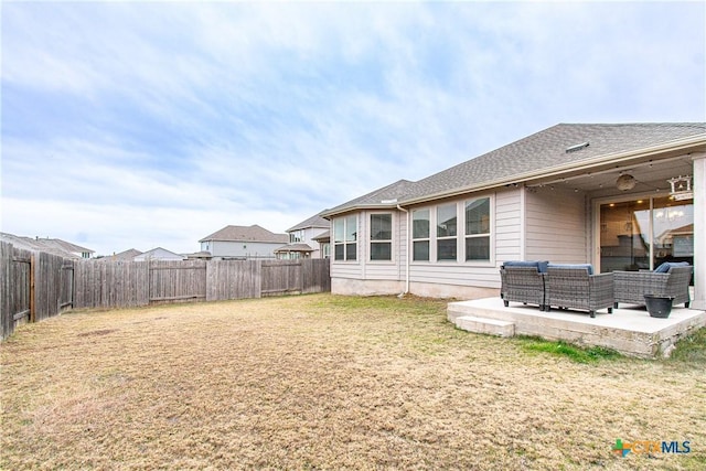 back of house with an outdoor living space, a yard, and a patio