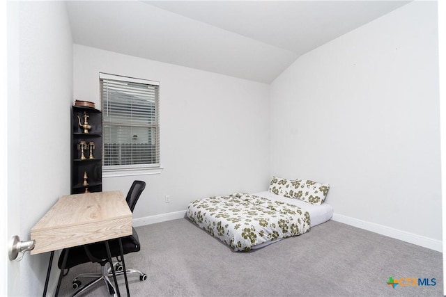 bedroom featuring vaulted ceiling and carpet floors