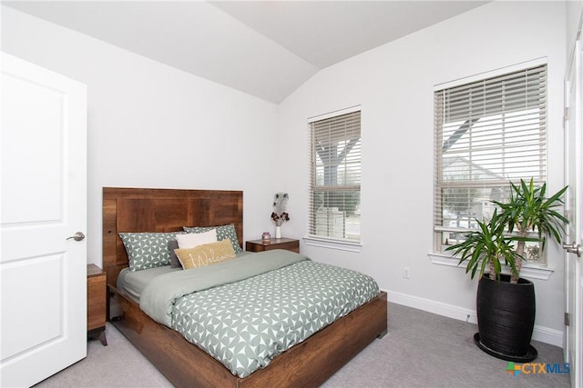 carpeted bedroom featuring vaulted ceiling