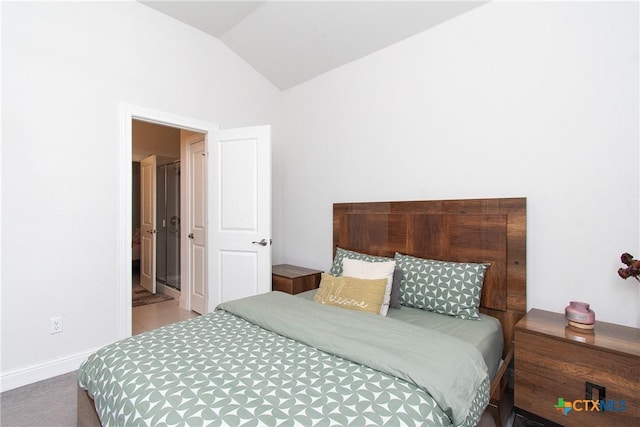 carpeted bedroom with vaulted ceiling