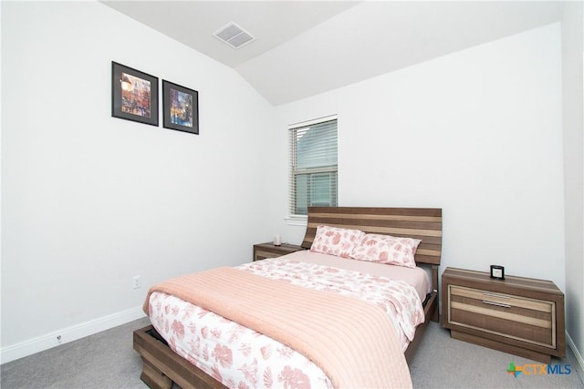 bedroom featuring vaulted ceiling and carpet