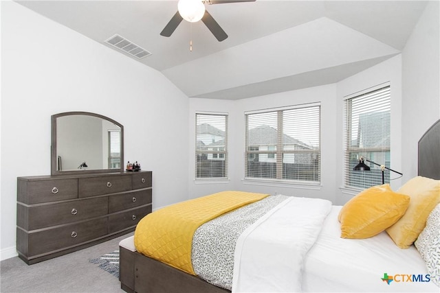 bedroom with ceiling fan, light colored carpet, and vaulted ceiling