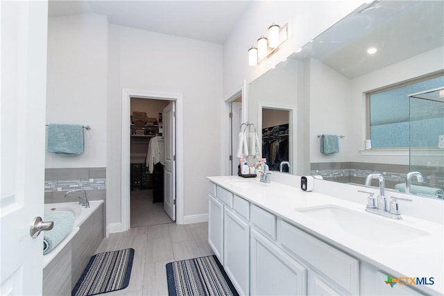 bathroom featuring vanity and tiled bath