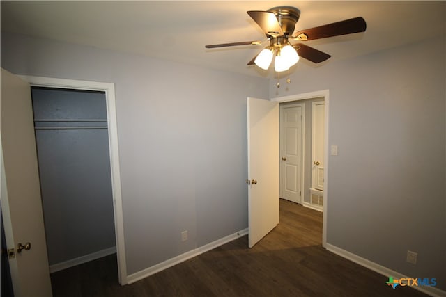 unfurnished bedroom with ceiling fan, a closet, and dark hardwood / wood-style flooring